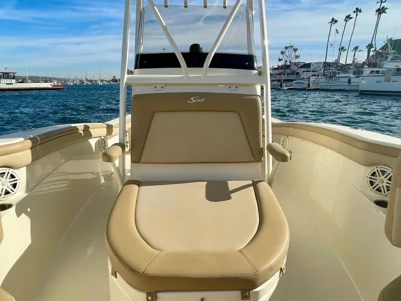 Slide: The Image of 2020 Scout 215 XSF boat interior with beige seating, docked in a marina. - 31