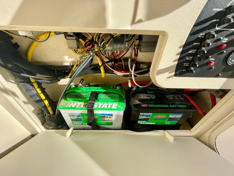 Slide: The Image of 2020 Scout 215 XSF boat battery compartment with wiring and Interstate batteries. - 38