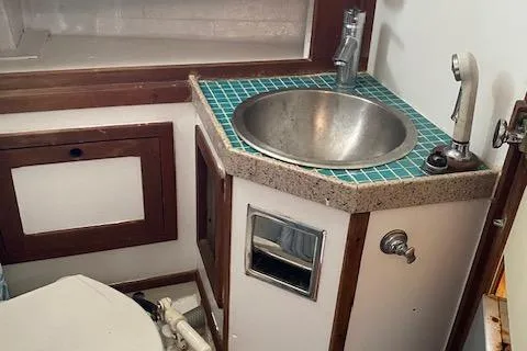 Slide: The Image of 1973 Tartan 34 boat bathroom with sink and tiled countertop. - 6