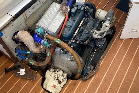 Slide: The Image of Engine compartment of a 1973 Tartan 34 sailboat, featuring visible hoses and components. - 9