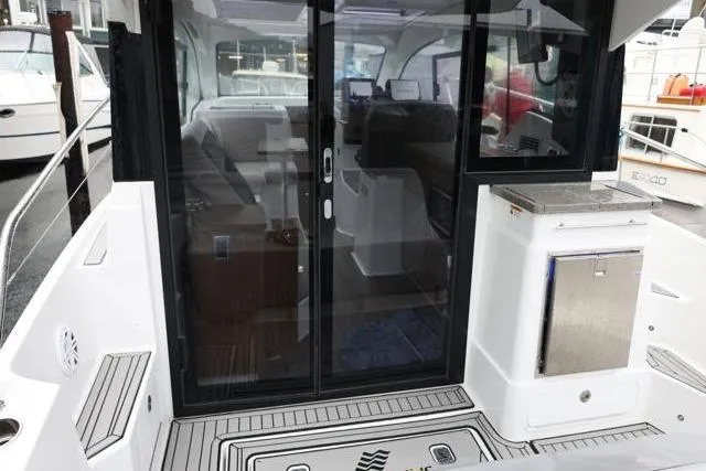 Slide: The Image of 2021 Four Winns V355 Coupe boat with sleek cockpit and modern interior design. - 13