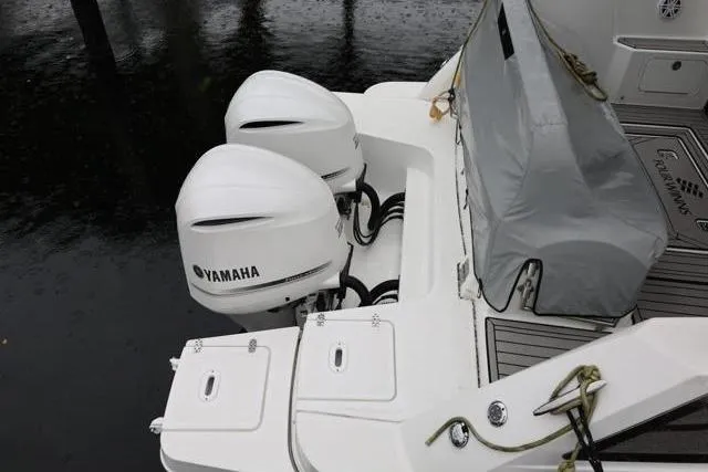 Slide: The Image of 2021 Four Winns V355 Coupe with dual Yamaha outboard engines, docked on water. - 16