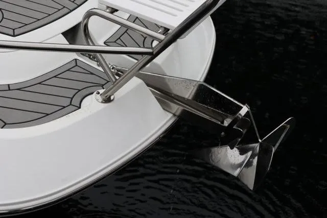 Slide: The Image of 2021 Four Winns V355 Coupe boat anchor and deck detail on water. - 19