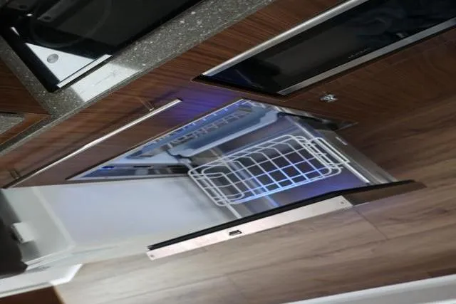 Slide: The Image of Interior view of 2021 Four Winns V355 Coupe kitchen with modern appliances. - 2