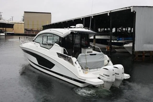 Slide: The Image of 2021 Four Winns V355 Coupe boat with twin Yamaha engines in a marina. - 20