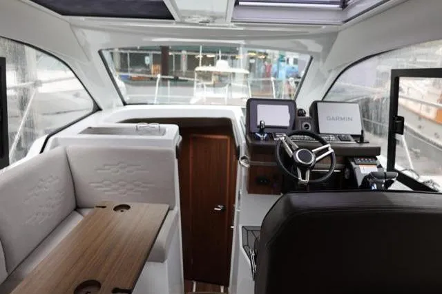 Slide: The Image of Interior of 2021 Four Winns V355 Coupe boat with modern helm and seating area. - 3