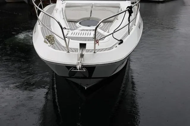 Slide: The Image of 2021 Four Winns V355 Coupe boat docked on calm water. - 30