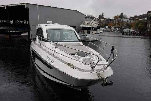 Slide: The Image of 2021 Four Winns V355 Coupe boat docked on a rainy day. - 33
