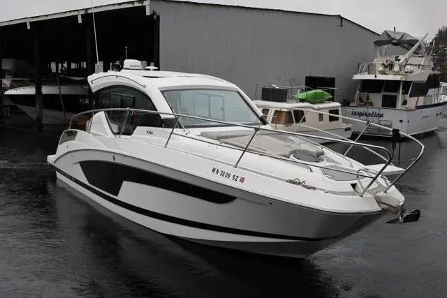 Slide: The Image of 2021 Four Winns V355 Coupe boat docked in a marina. - 35