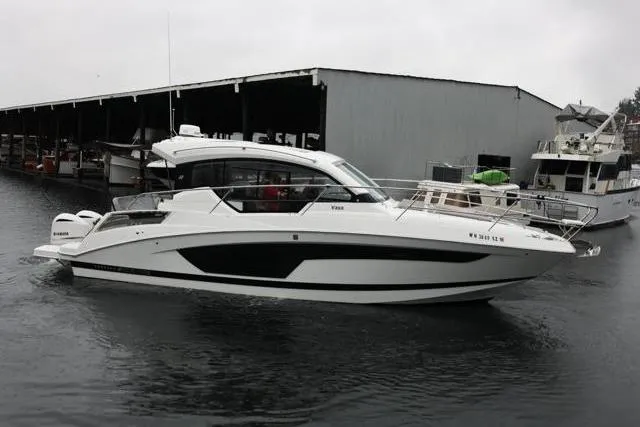 Slide: The Image of 2021 Four Winns V355 Coupe boat docked at marina on a cloudy day. - 37