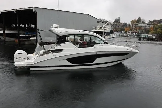 Slide: The Image of 2021 Four Winns V355 Coupe boat docked on a calm, overcast day. - 38