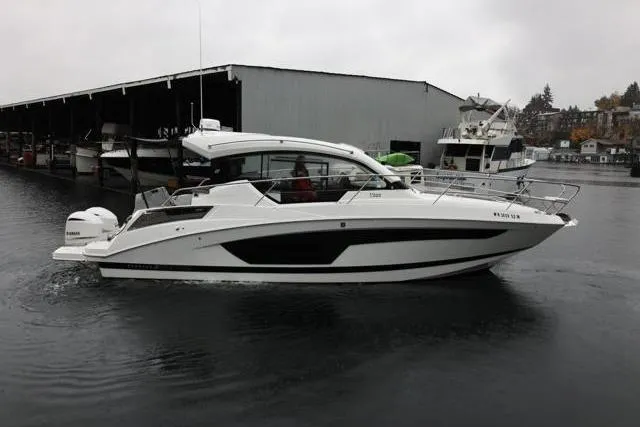 Slide: The Image of 2021 Four Winns V355 Coupe boat docked in a marina on a cloudy day. - 39