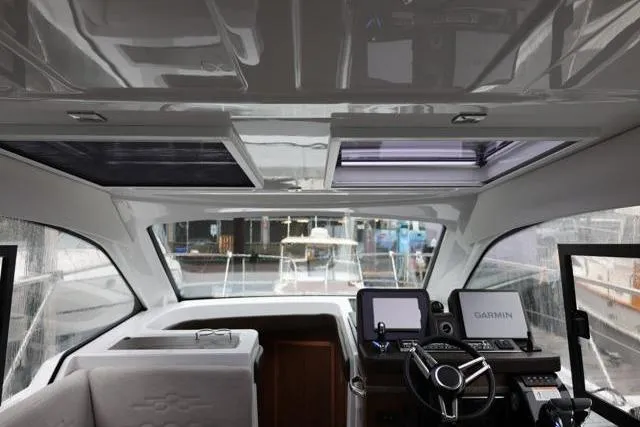 Slide: The Image of Interior view of 2021 Four Winns V355 Coupe boat cockpit with modern navigation equipment. - 4