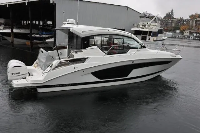 Slide: The Image of 2021 Four Winns V355 Coupe boat docked in a marina, featuring sleek design and Yamaha engines. - 41