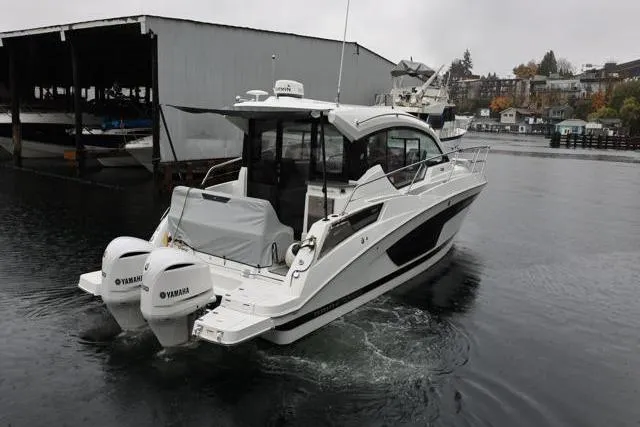 Slide: The Image of 2021 Four Winns V355 Coupe boat with Yamaha engines on a calm waterway. - 42