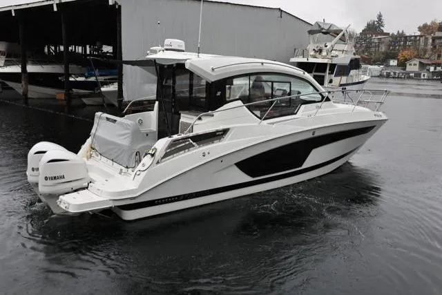 Slide: The Image of 2021 Four Winns V355 Coupe boat with Yamaha engines docked in a marina. - 43