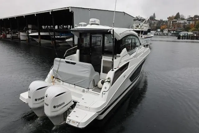 Slide: The Image of 2021 Four Winns V355 Coupe boat with Yamaha engines on a calm waterway. - 44