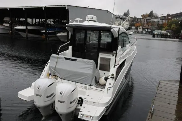 Slide: The Image of 2021 Four Winns V355 Coupe boat docked with twin Yamaha 300 engines. - 46