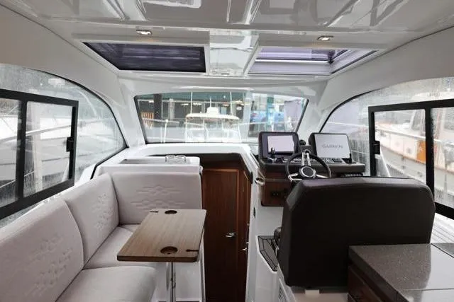 Slide: The Image of Interior of 2021 Four Winns V355 Coupe boat with modern seating and navigation equipment. - 48