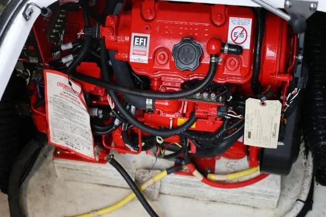 Slide: The Image of Engine compartment of 2021 Four Winns V355 Coupe, featuring a red EFI engine. - 50