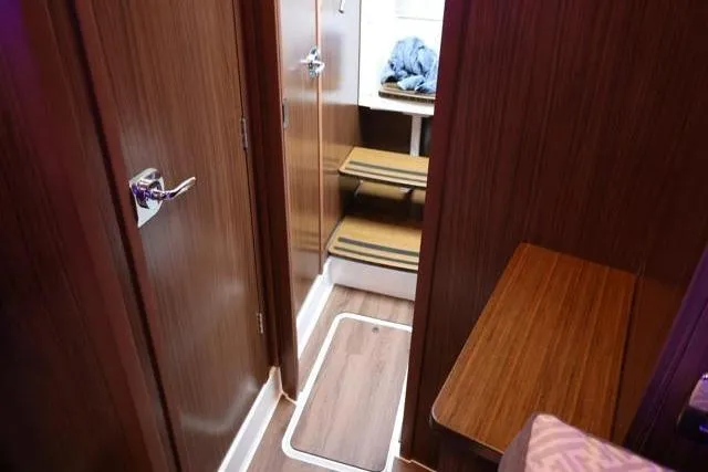 Slide: The Image of Interior of 2021 Four Winns V355 Coupe, featuring wooden cabinetry and compact design. - 53