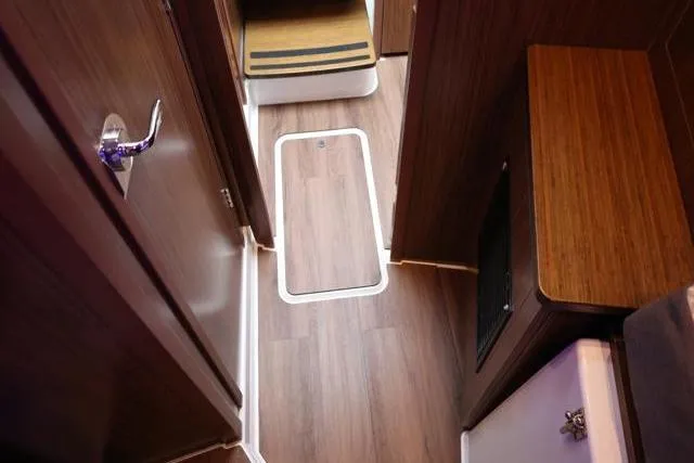 Slide: The Image of 2021 Four Winns V355 Coupe interior with wood flooring and modern design. - 54