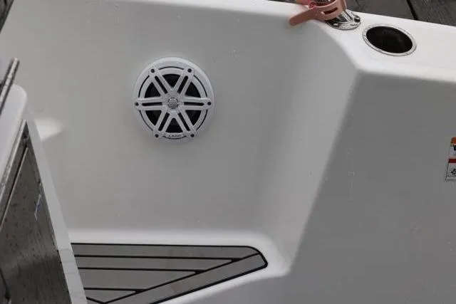 Slide: The Image of 2021 Four Winns V355 Coupe boat interior with speaker and cup holder. - 6