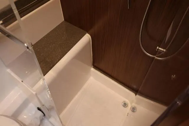 Slide: The Image of 2021 Four Winns V355 Coupe bathroom with modern shower and sleek design. - 64