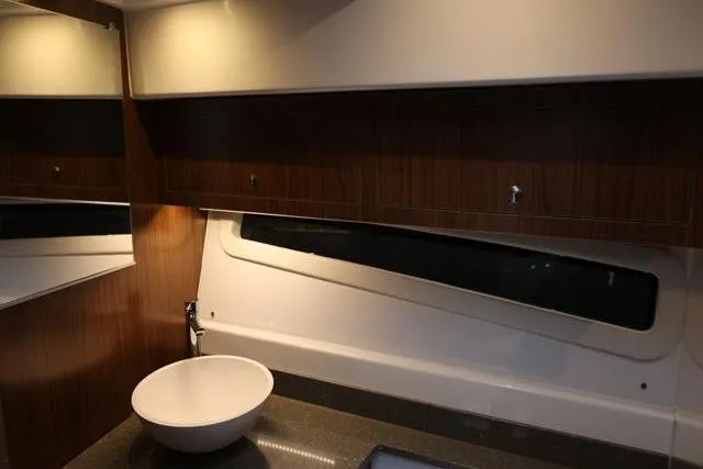Slide: The Image of Interior of 2021 Four Winns V355 Coupe, featuring modern bathroom with sleek design. - 65