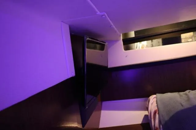 Slide: The Image of Interior cabin of 2021 Four Winns V355 Coupe with ambient lighting and window view. - 67