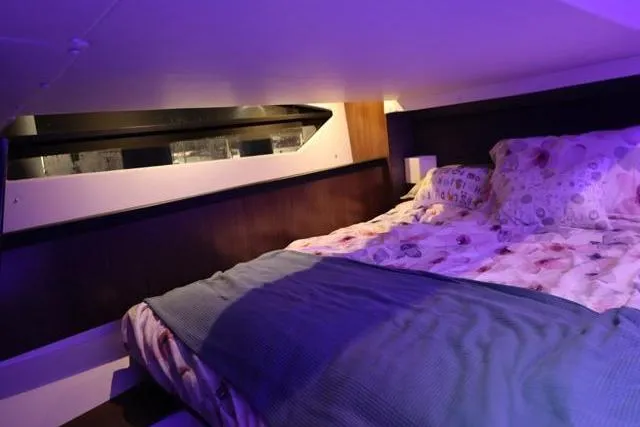 Slide: The Image of Cozy cabin interior of 2021 Four Winns V355 Coupe with ambient lighting. - 71