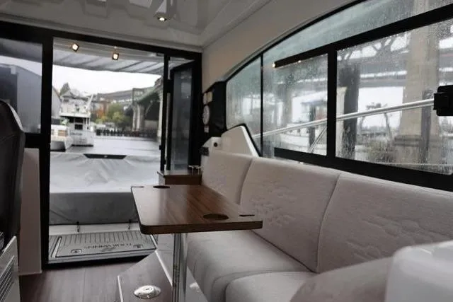 Slide: The Image of Interior of 2021 Four Winns V355 Coupe boat with modern seating and table. - 74