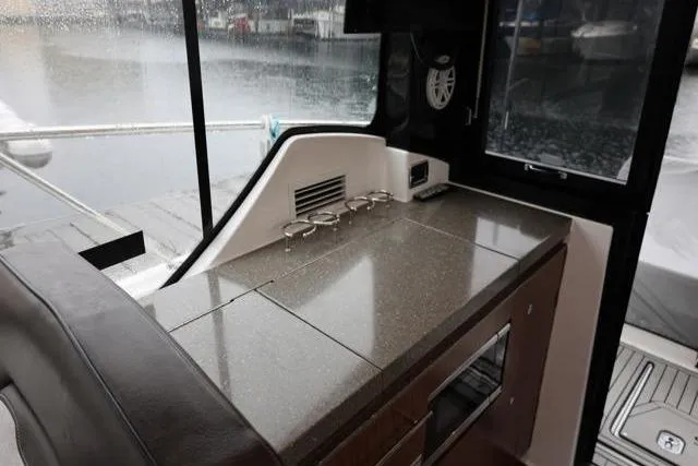 Slide: The Image of 2021 Four Winns V355 Coupe interior with sleek countertop and modern amenities. - 76