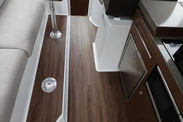 Slide: The Image of Interior of 2021 Four Winns V355 Coupe with wood flooring and modern cabinetry. - 89