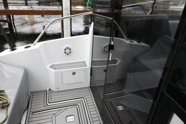 Slide: The Image of 2021 Four Winns V355 Coupe boat deck with sleek design and modern features. - 9