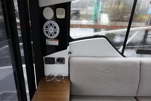 Slide: The Image of Interior of 2021 Four Winns V355 Coupe, featuring seating and audio system. - 91