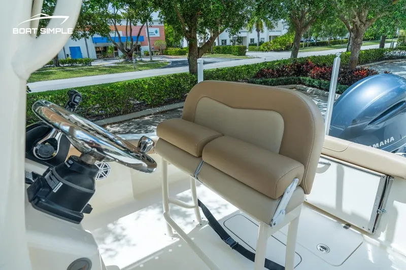 Slide: The Image of 2023 Scout 215 XSF boat interior with steering wheel and cushioned seating. - 11