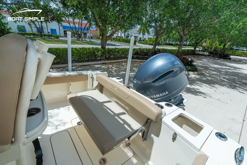 Slide: The Image of 2023 Scout 215 XSF boat with Yamaha engine, beige seating, and outdoor setting. - 15