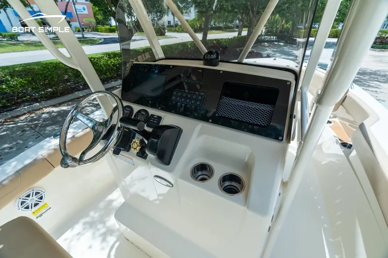 Slide: The Image of 2023 Scout 215 XSF boat dashboard with steering wheel and controls. - 6