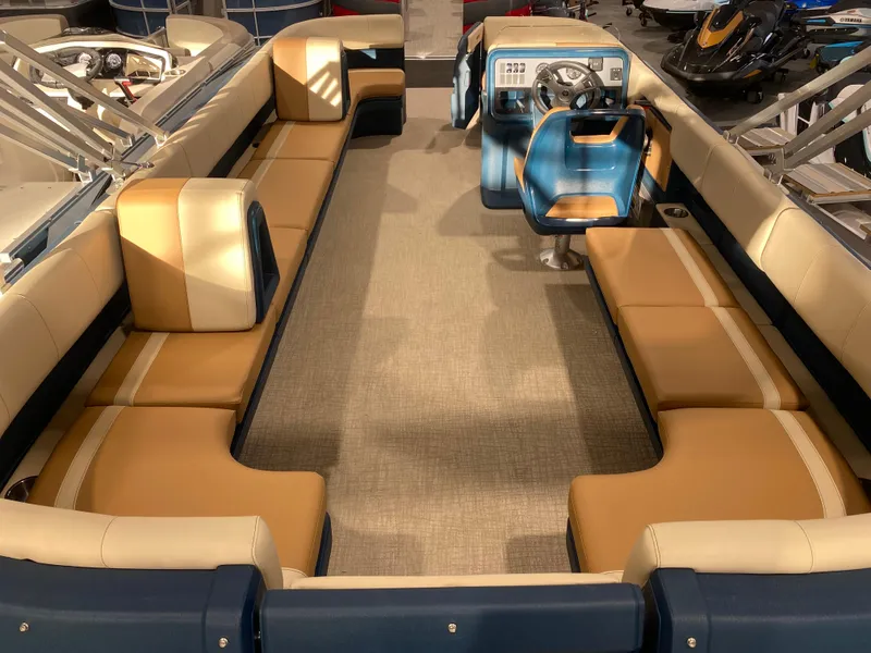 Slide: The Image of 2025 Avalon AURA 2385 QL pontoon boat interior with spacious seating and modern helm. - 4