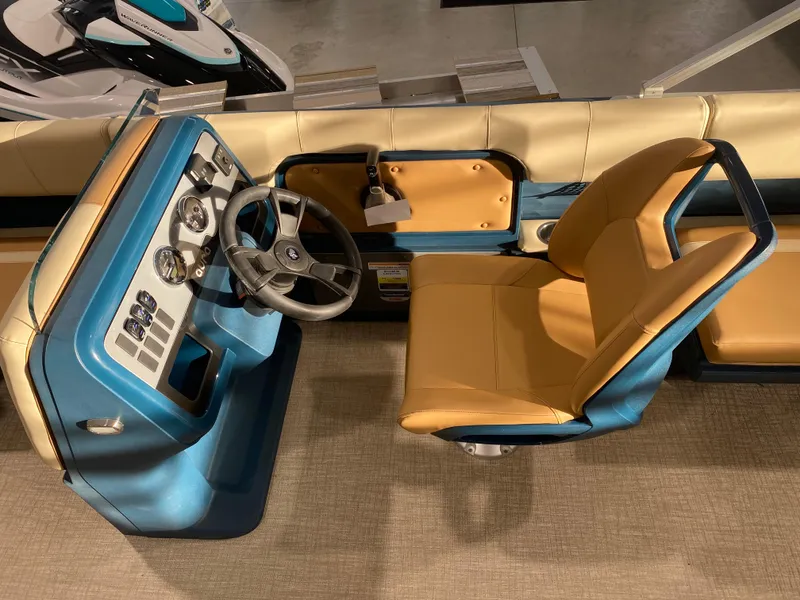 Slide: The Image of Interior of 2025 Avalon AURA 2385 QL boat with blue and tan seating. - 5