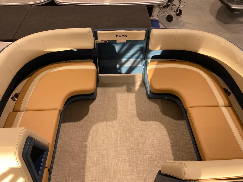 Slide: The Image of Interior seating of 2025 Avalon AURA 2385 QL pontoon boat, featuring tan and blue upholstery. - 7