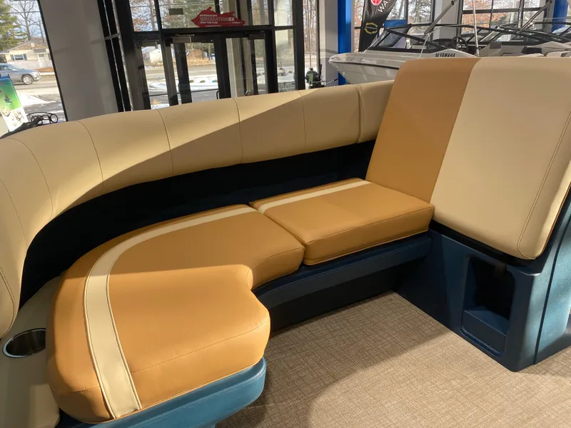 Slide: The Image of Luxurious seating in the 2025 Avalon AURA 2385 QL boat, featuring tan and cream upholstery. - 8