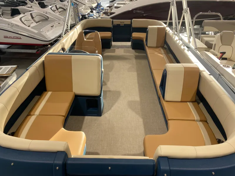 Slide: The Image of 2025 Avalon AURA 2385 QL pontoon boat interior with tan and blue seating. - 9