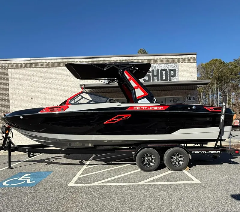 The Image of 2025 Centurion Ri245 boat on trailer, parked in front of a shop. - 0