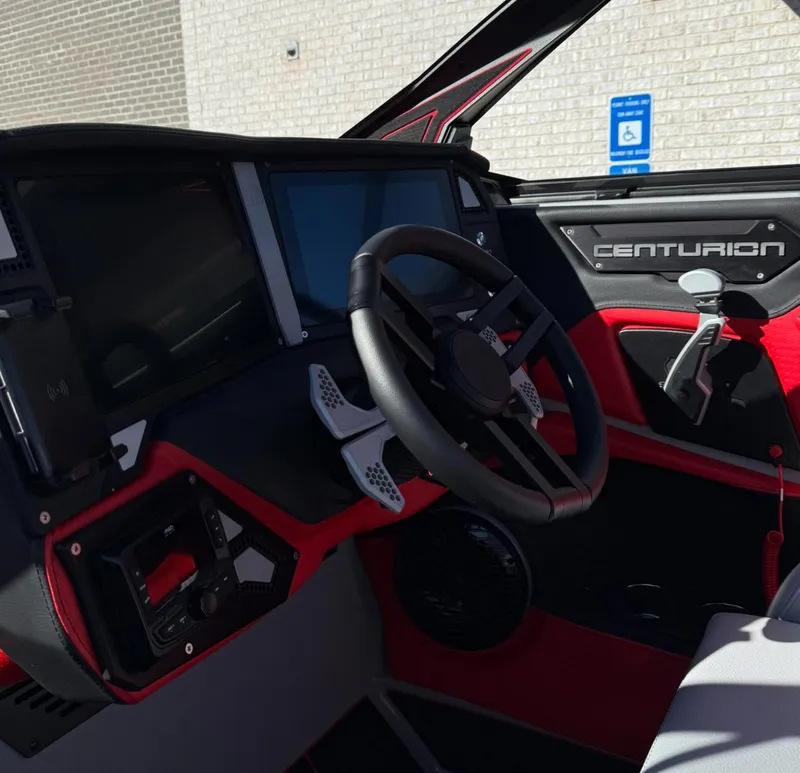 Slide: The Image of Interior of 2025 Centurion Ri245 boat with modern dashboard and steering wheel. - 11