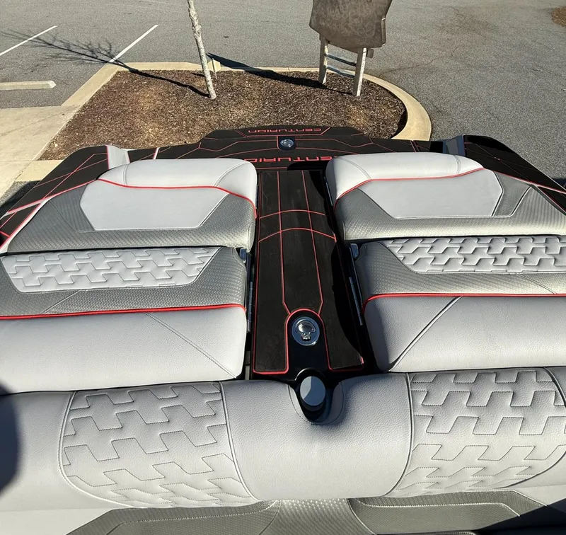 Slide: The Image of 2025 Centurion Ri245 boat interior with gray and red-accented seating. - 18