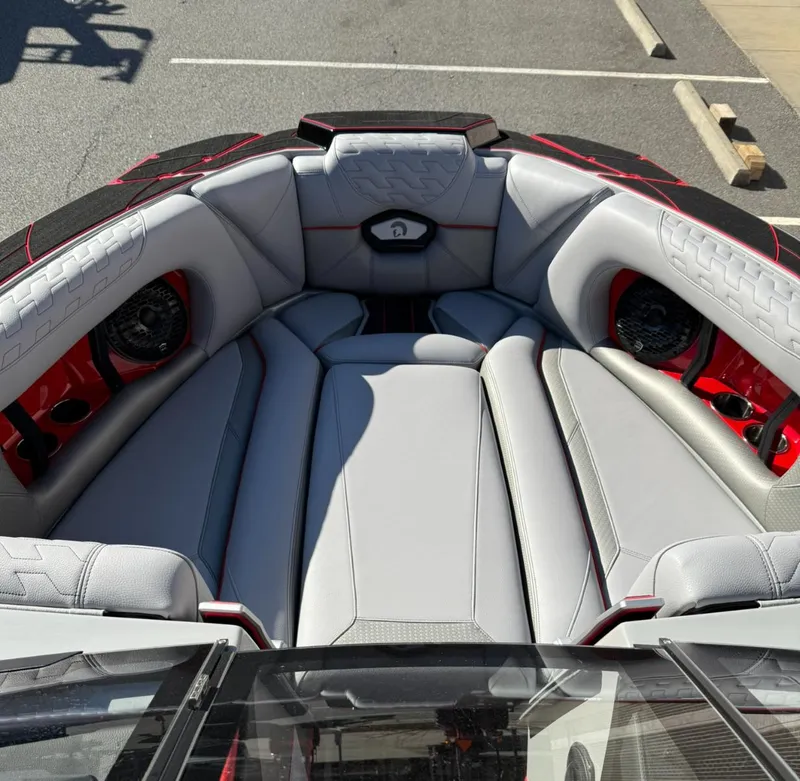 Slide: The Image of 2025 Centurion Ri245 boat interior with gray seating and red accents. - 21