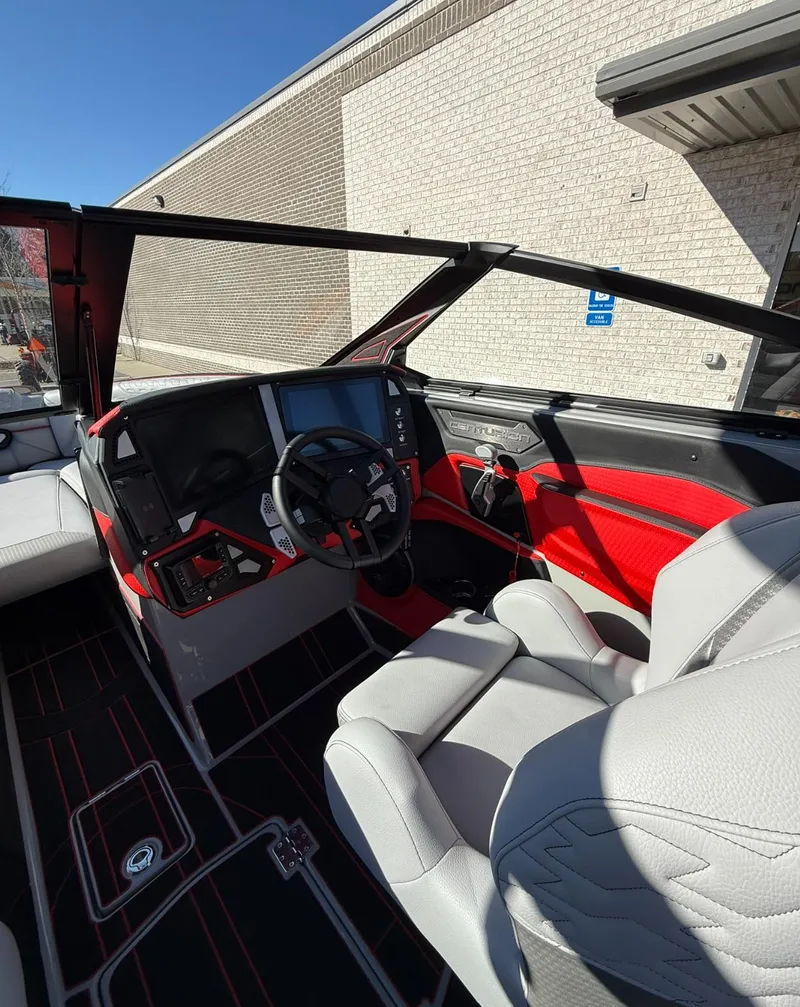 Slide: The Image of 2025 Centurion Ri245 boat interior with modern dashboard and red accents. - 23