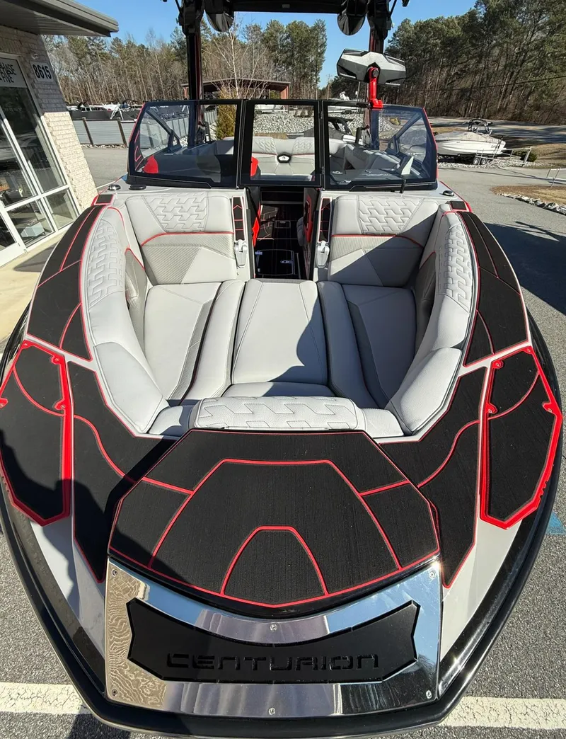 Slide: The Image of 2025 Centurion Ri245 boat with sleek black and red design, luxurious seating, and modern features. - 5